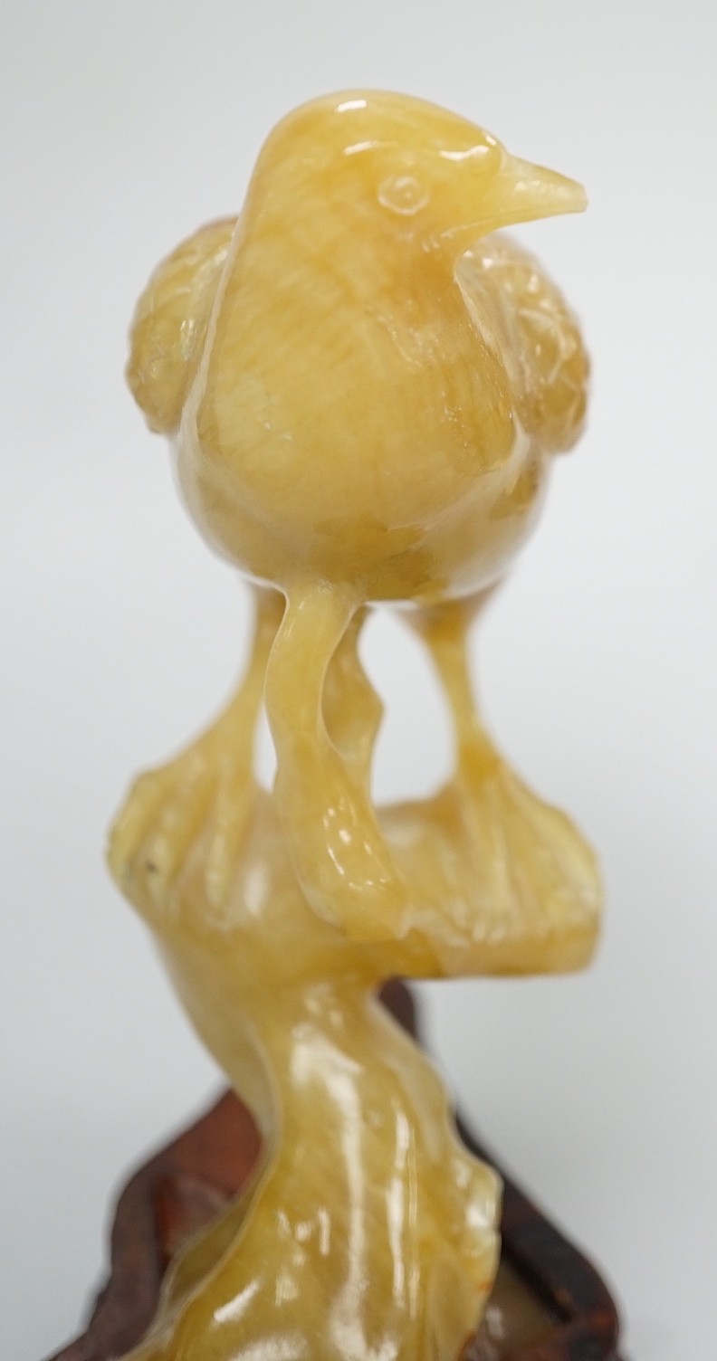 A Chinese chalcedony carving of a bird, wood stand, total height 15.5 cm
